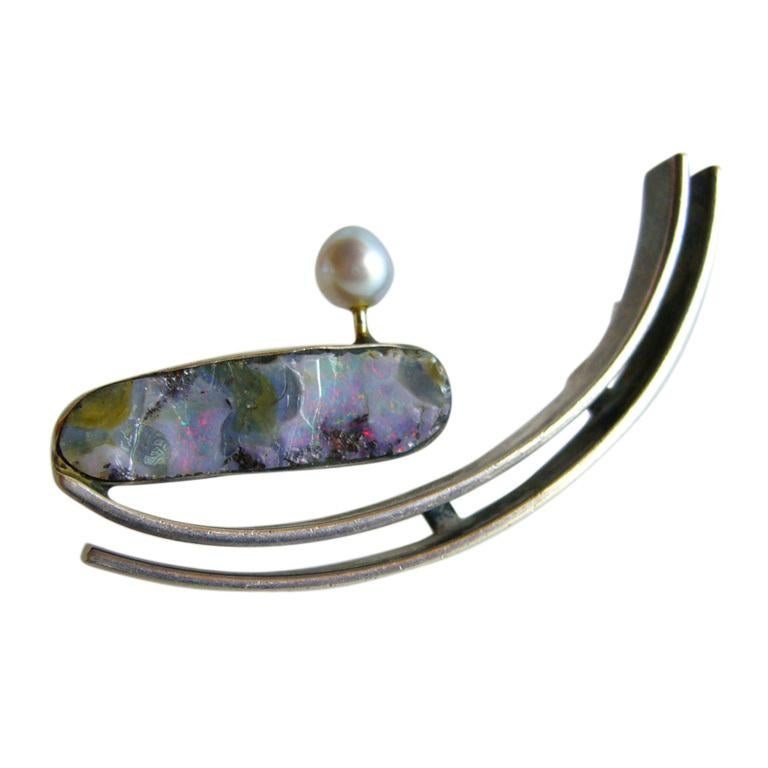 An opal and pearl brooch designed by Idella LaVista of New York City.  

La Vista opened her workshop and store in midtown Manhattan in the 1950's. Selling a wide range of objects such as lamps, ceramics and other home décor, she also held exhibits