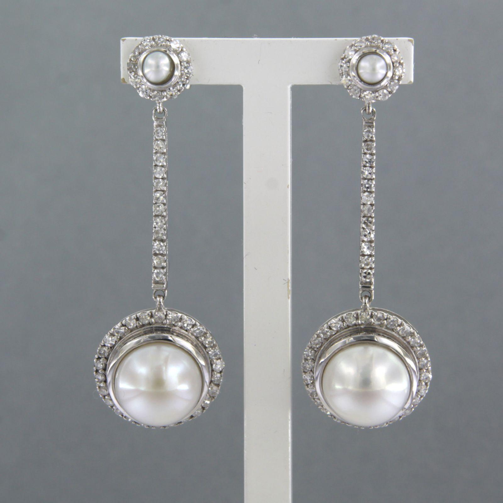 Boucles d'oreilles en or blanc 14k serties de perles et d'un diamant taille unique jusqu'à 0.82ct - F/G - VS/SI 

Description détaillée :

la taille des boucles d'oreilles est de 4,0 cm de long par 1,4 cm de large

Poids total 7,5 grammes

set