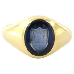 Signet ring with synthetic sapphire engraved with a family crest 18k gold