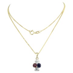 Collier pendentif bicolore en or jaune 14k avec rubis, saphir et diamants