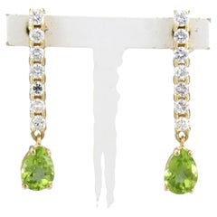 Earrings with peridot and brilliant cut diamonds up to 0.58ct 18k gold 3.7 grams