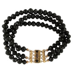Bracelet à trois rangées de perles de grenat, avec des fermoirs en or 14 carats ornés de grenats et de perles
