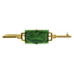 14k gold brooch with a jade carved with Chinese dragon and single cut diamonds