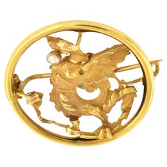 ART NOUVEAU 18k gold brooch in shape of a griffon with a pearl in its beak