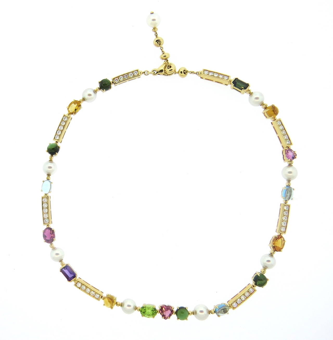 An 18k yellow gold necklace set with blue topaz, citrine, green and pink tourmaline, pearls (7.4mm) and diamonds (approx. 2cts).  The necklace can be worn at 14