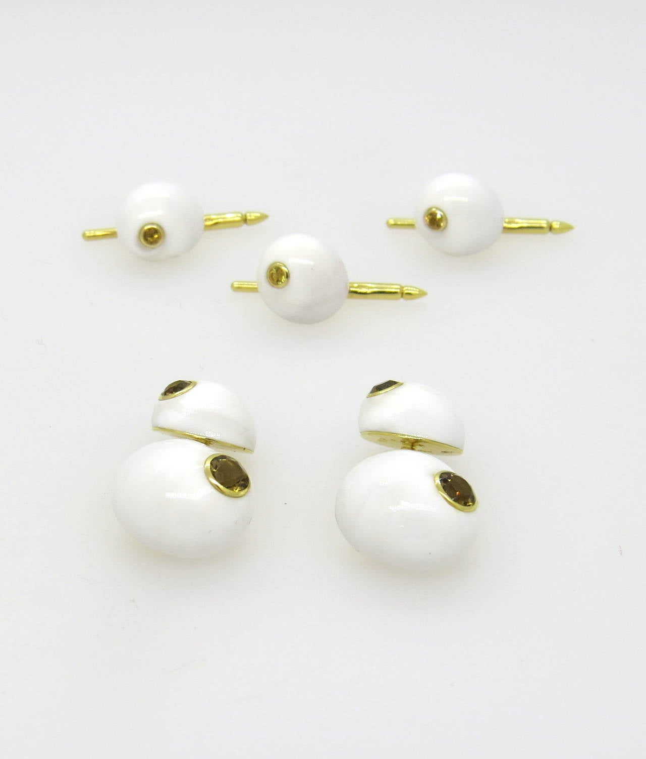 An 18k yellow gold cufflink and stud set made of shells set with citrines.  The cufflinks measure 17mm x 15mm and the studs measure 12.8mm x 11.4mm.  The weight of the set is 19 grams.