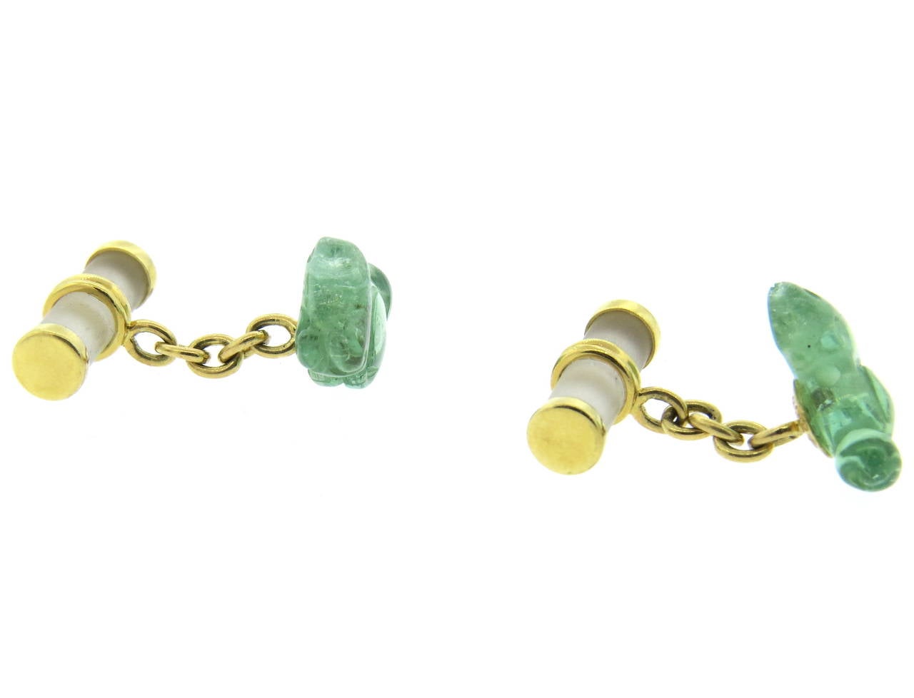 A pair of 18k yellow gold cufflinks set with crystal and carved green gemstones depicting squirrels.  The cufflinks measure 16.6mm x 10mm and 18.8mm x 7mm.  They weigh 7.9 grams.
