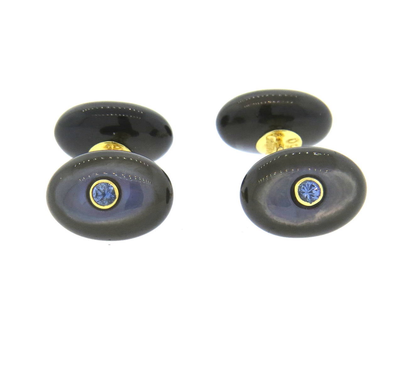 A pair of 18k yellow gold cufflinks with black mother of pearl and 2.5mm iolites.  Crafted by Trianon, the cufflinks measure 14mm x 10mm and weigh 7.6 grams.  Signed Trianon, 750 with a serial number.
