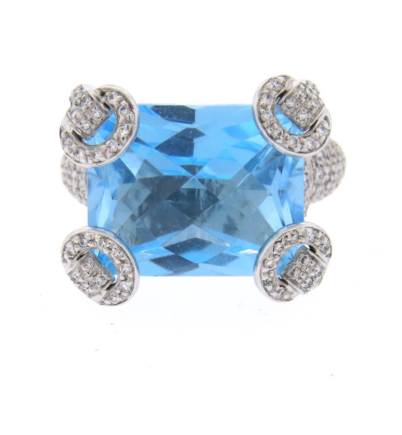 An 18k white gold ring set with 0.90cts in G/VS diamonds and a 17ct blue topaz.  Crafted by Gucci for their Horsebit collection, the ring is a size 6.75.  The top of the ring is 20mm x 17mm.  The ring weighs 16.3 grams.  Currently retailed by Gucci