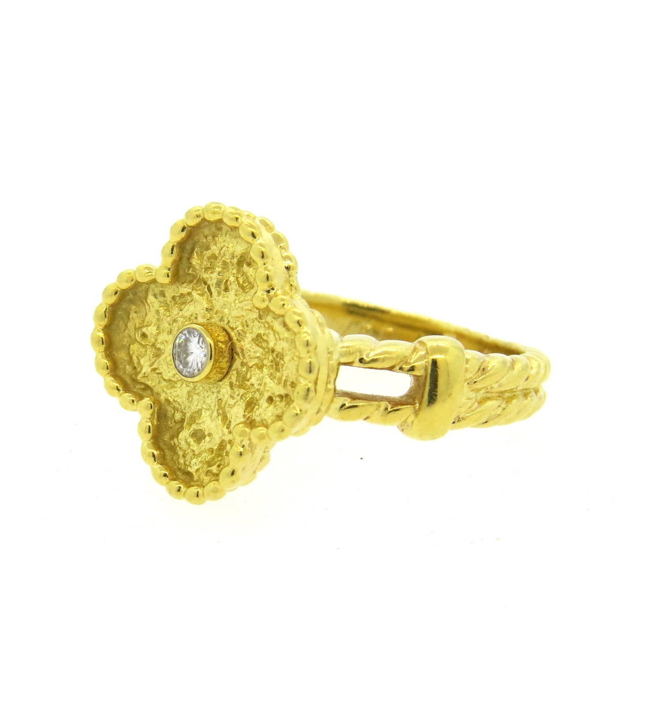 An 18k yellow gold ring set with a diamond G/VS approx 0.08cts.  Crafted by Van Cleef & Arpels, the ring is a size 5.5 and the top measures 15mm x 15mm.  The ring weighs 7.3 grams.