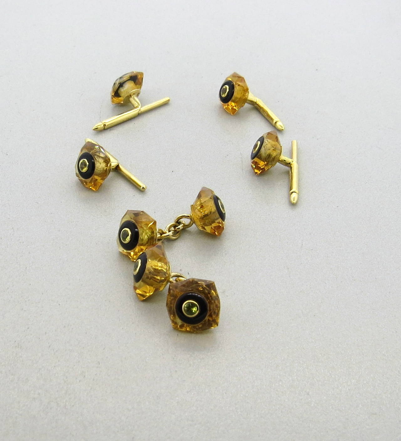 An 18k yellow gold set of cufflinks and studs crafted from amber, onyx and citrine.  Crafted by Trianon, the cufflinks measure 11mm x 11mm and the studs measure 10mm x 10mm.  The weight of the set is 14.5 grams.  The pieces are marked with the