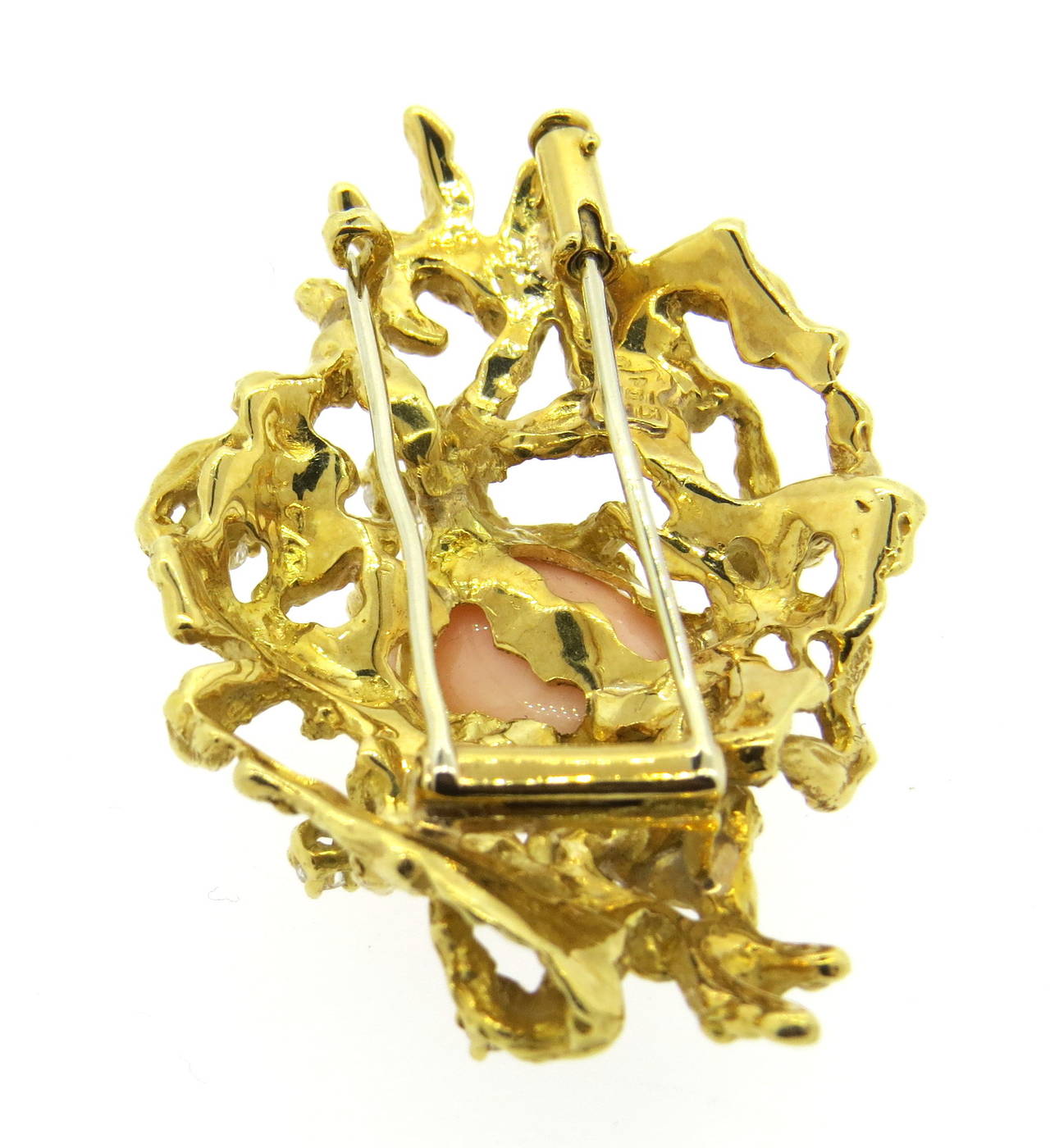 18k gold free form brooch by Arthur King, featuring oval coral, surrounded with diamonds. Brooch is 59mm x 35mm. Marked King and 18k. weight - 35.9gr