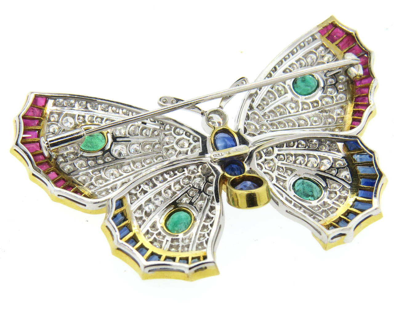 18k gold butterfly brooch, set with approximately 6.60ctw in diamonds, sapphires, rubies and emeralds. Brooch measures 65mm x 43mm. Weight - 23.5gr