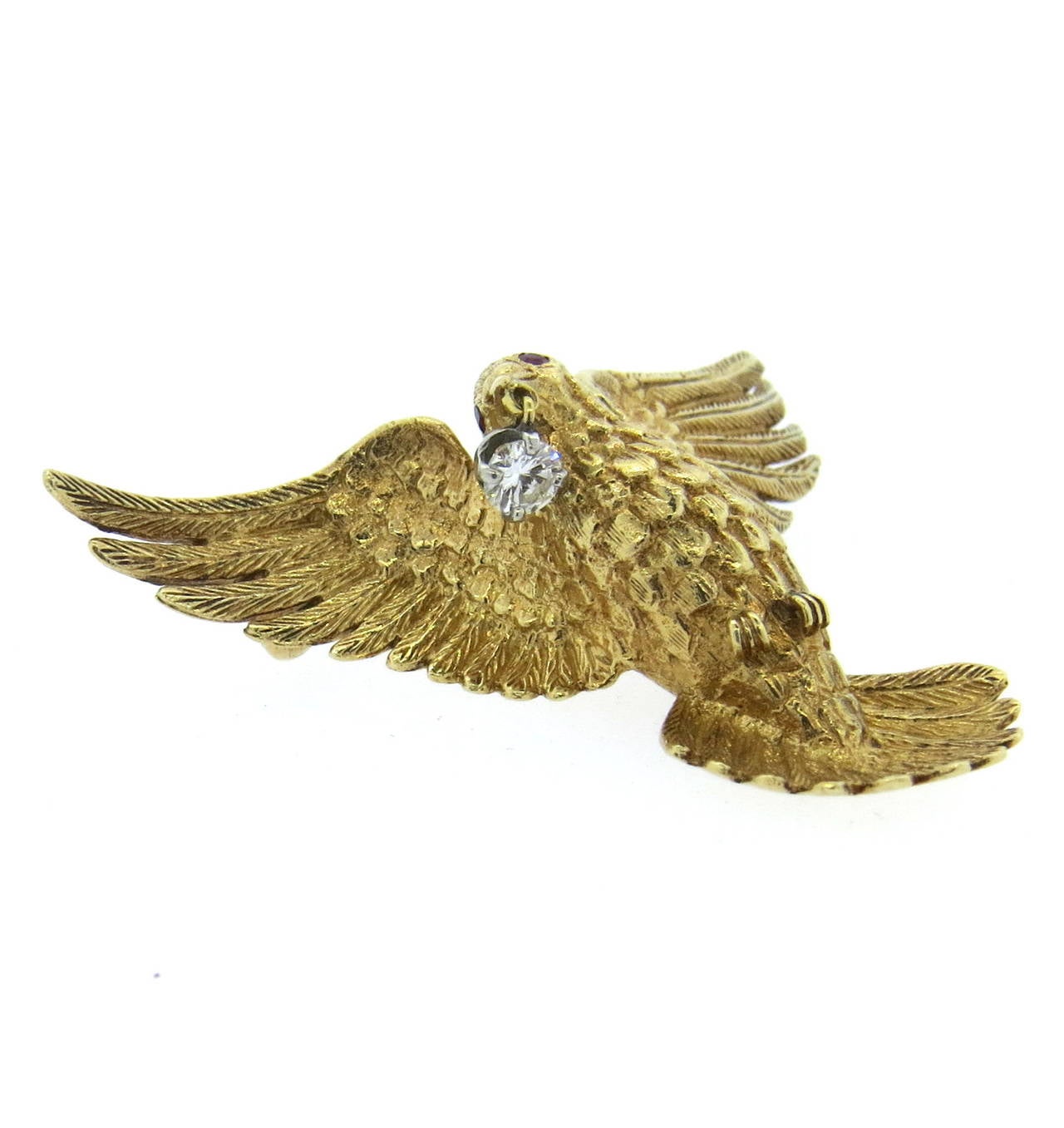 14k gold dove brooch, set with ruby eyes and one 0.18ct diamond. Brooch measures 40mm x 40mm. Weight of the piece - 11.5gr