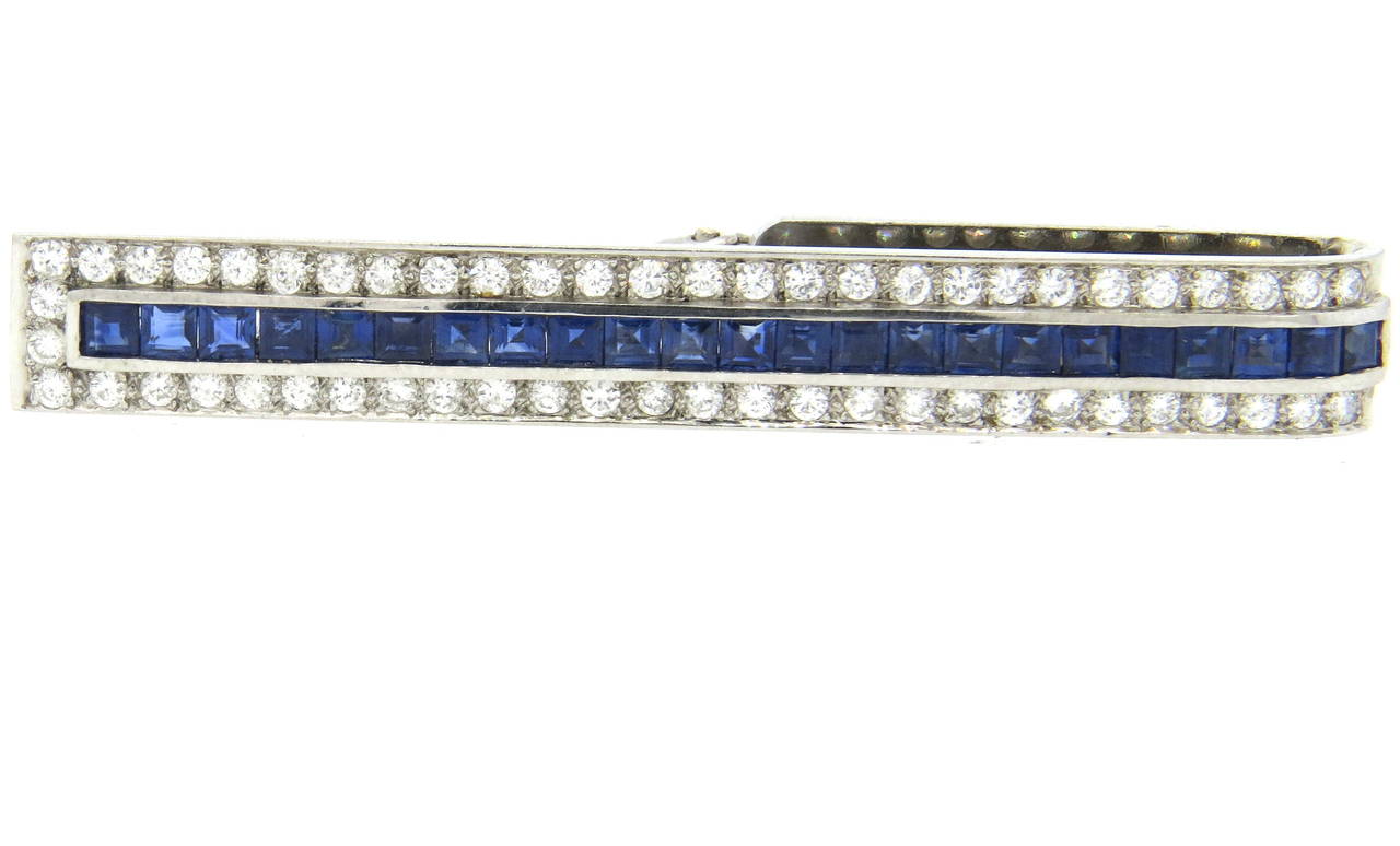 18k gold tie bar, set with approximately 0.70ctw in diamonds and 1.30ctw in blue sapphires. Bar measures 60mm x 8mm. Weight of the piece - 11.9gr