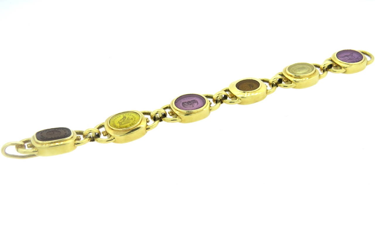 18k gold bracelet by Elizabeth Gage, featuring six Venetian glass intaglio stations, backed by mother of pearl. Bracelet is 8