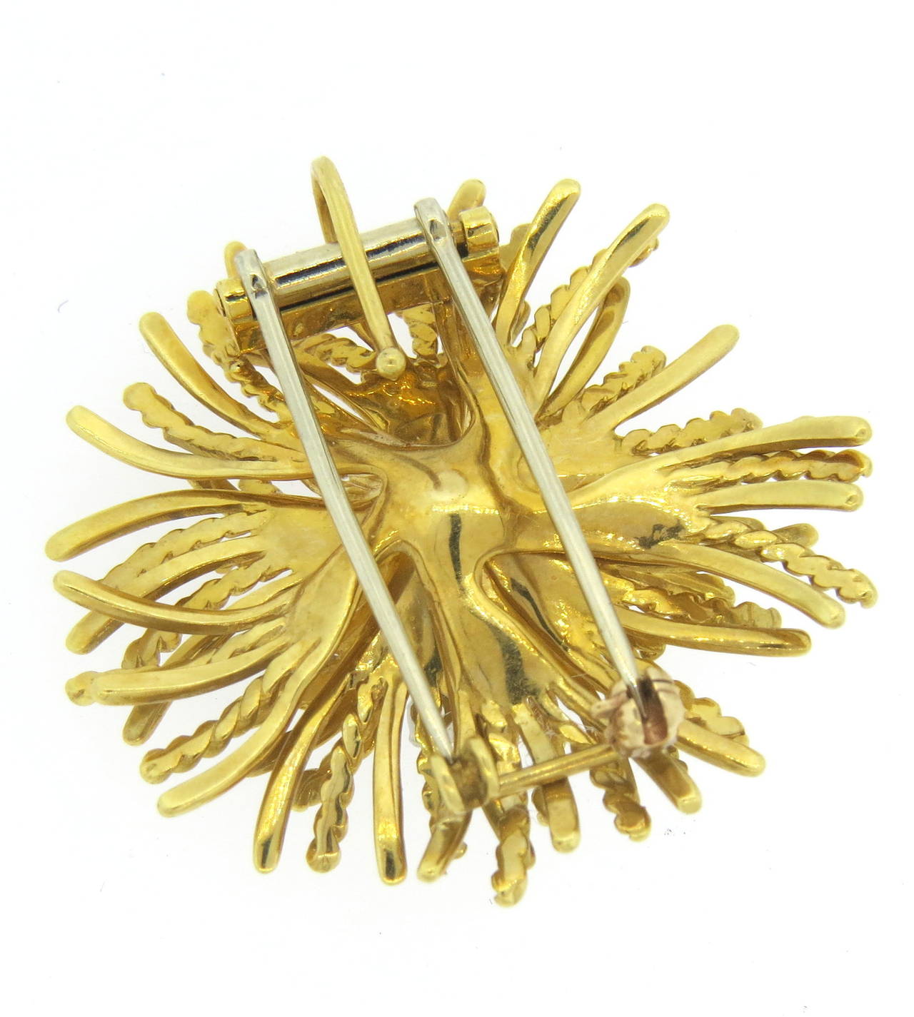 18k gold brooch pendant by McTeigue, set with approximately 0.60ctw in G/VS diamonds. Brooch measures40mm in diameter. Marked with makers mark and 18k. weight of the piece - 25 grams
