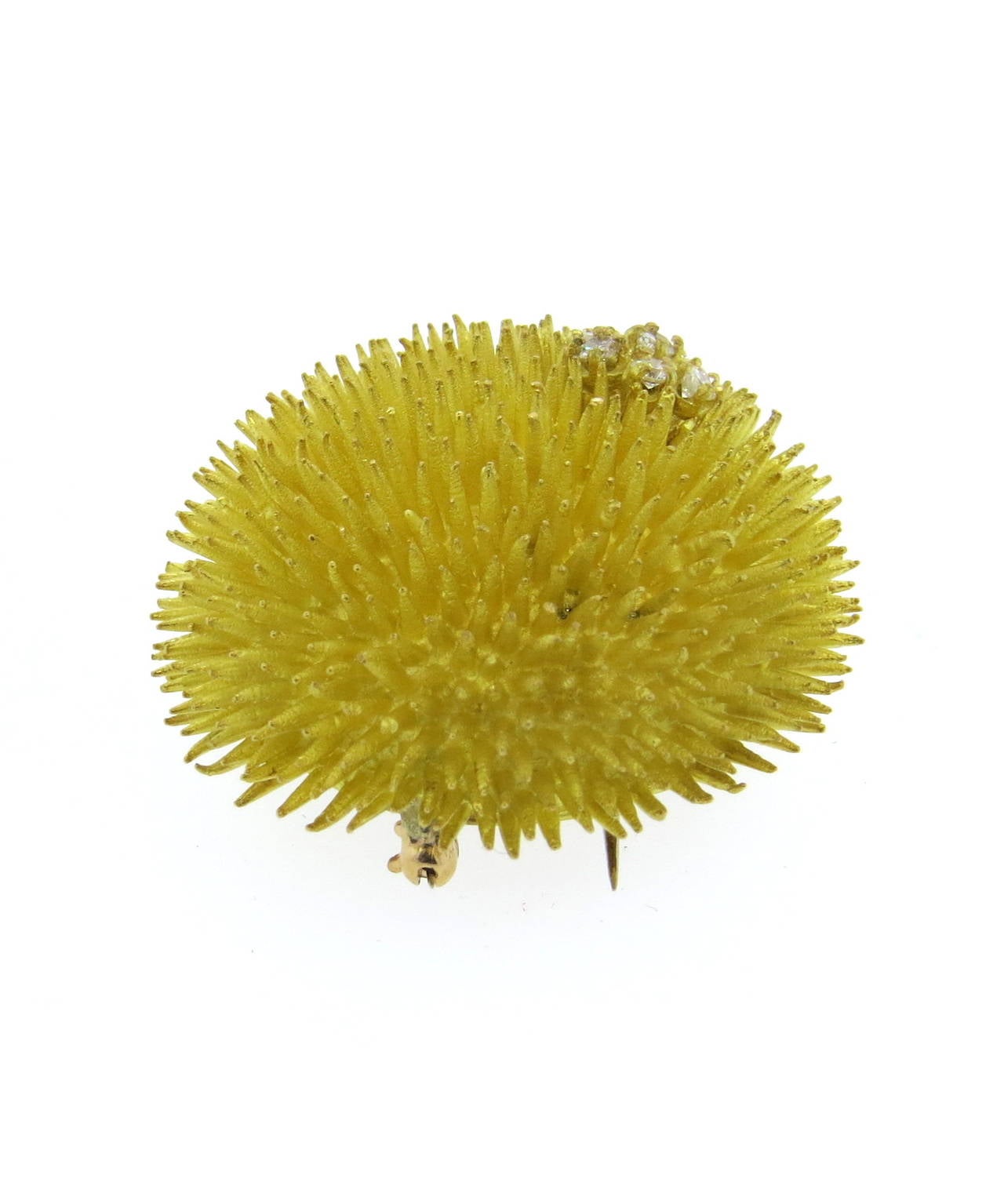 18k gold sea urchin brooch by Tiffany & Co, featuring diamond flower. Brooch is 35mm in diameter. Marked Tiffany & Co and 18k. weight - 42.8 grams
