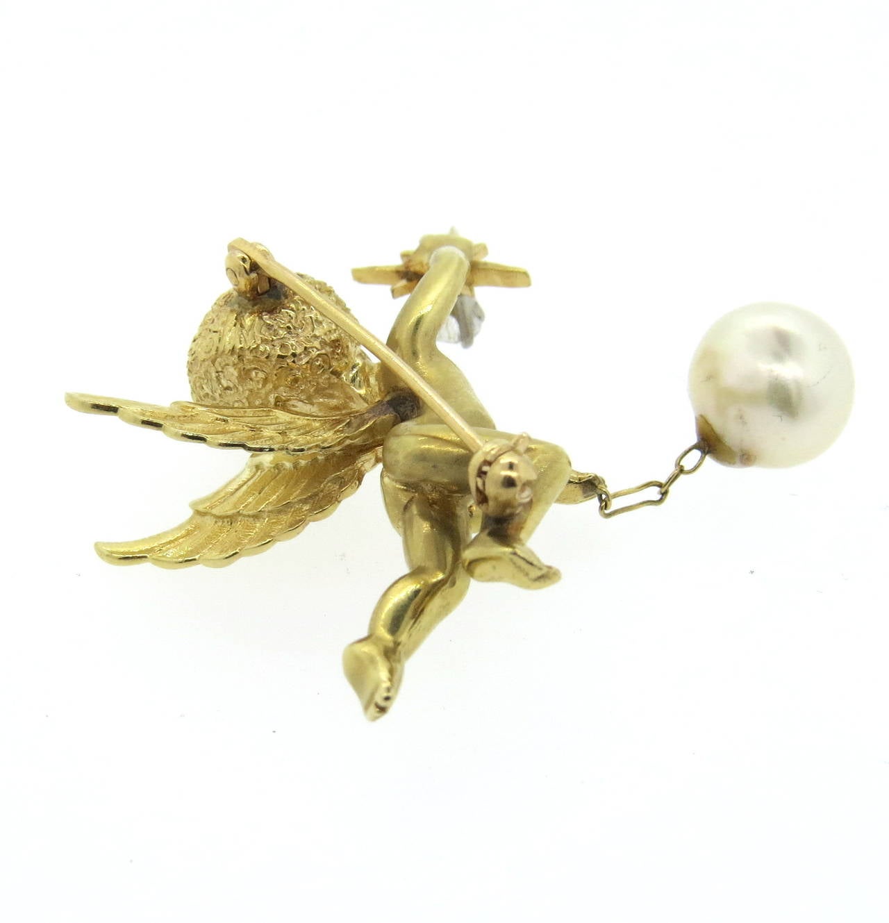 14k gold cherub brooch, set with a diamond, emerald eyes and 9.5mm pearl ball. Brooch is 40mm x 40mm . Weight of the piece - 17.1 grams