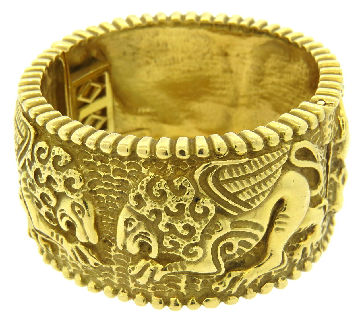 Massive bangle bracelet in 18k gold, featuring lion design, bracelet will fit up to 7