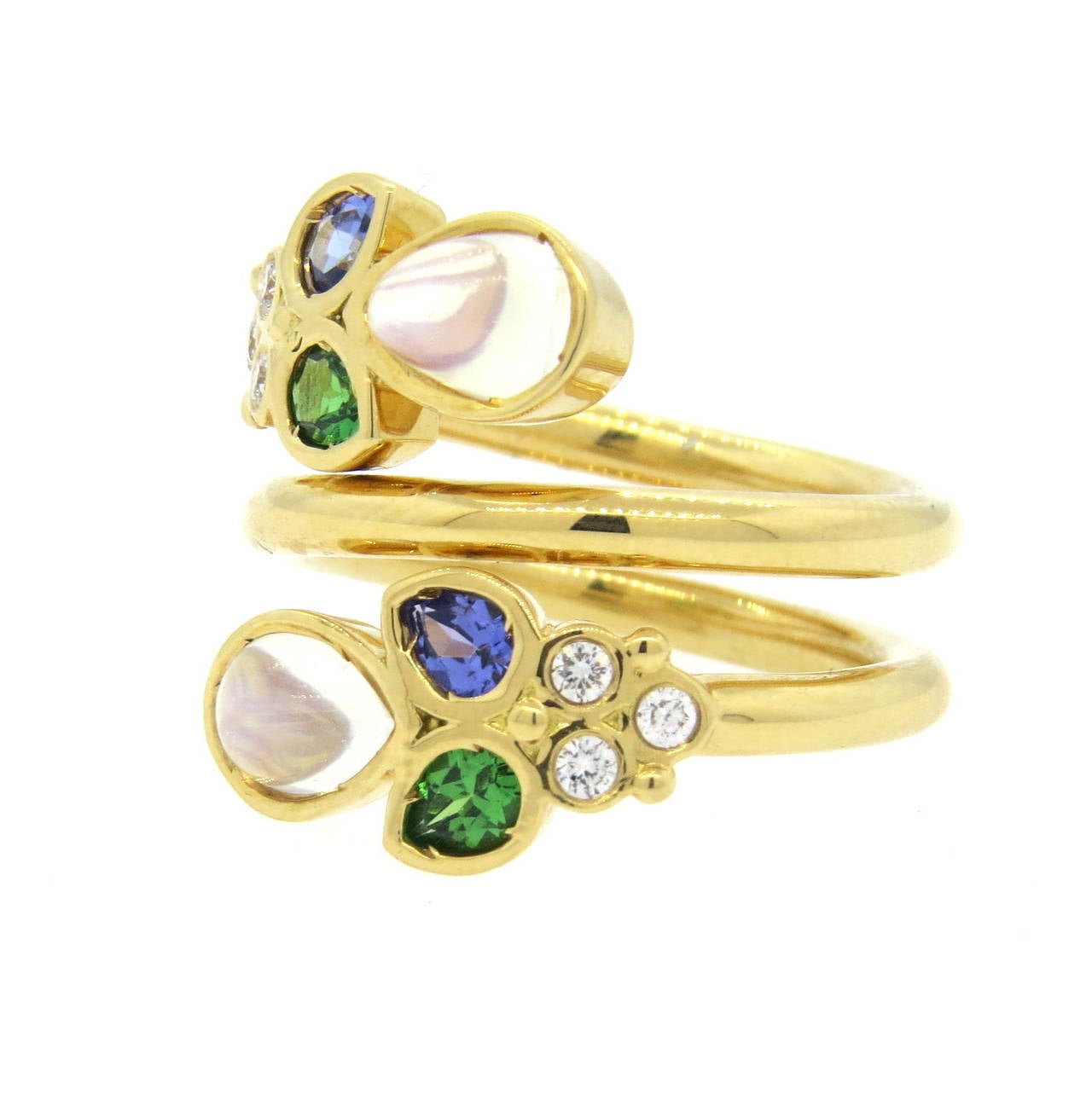 Temple St. Clair 18k gold wrap ring from Anima collection, featuring 0.15ctw in G/VS diamonds, moonstones, tsavorites and tanzanite gemstones. Ring size 7 1/4, ring is 21mm wide. Marked 750 and with Temple hallmark. Weight of the piece - 13 grams