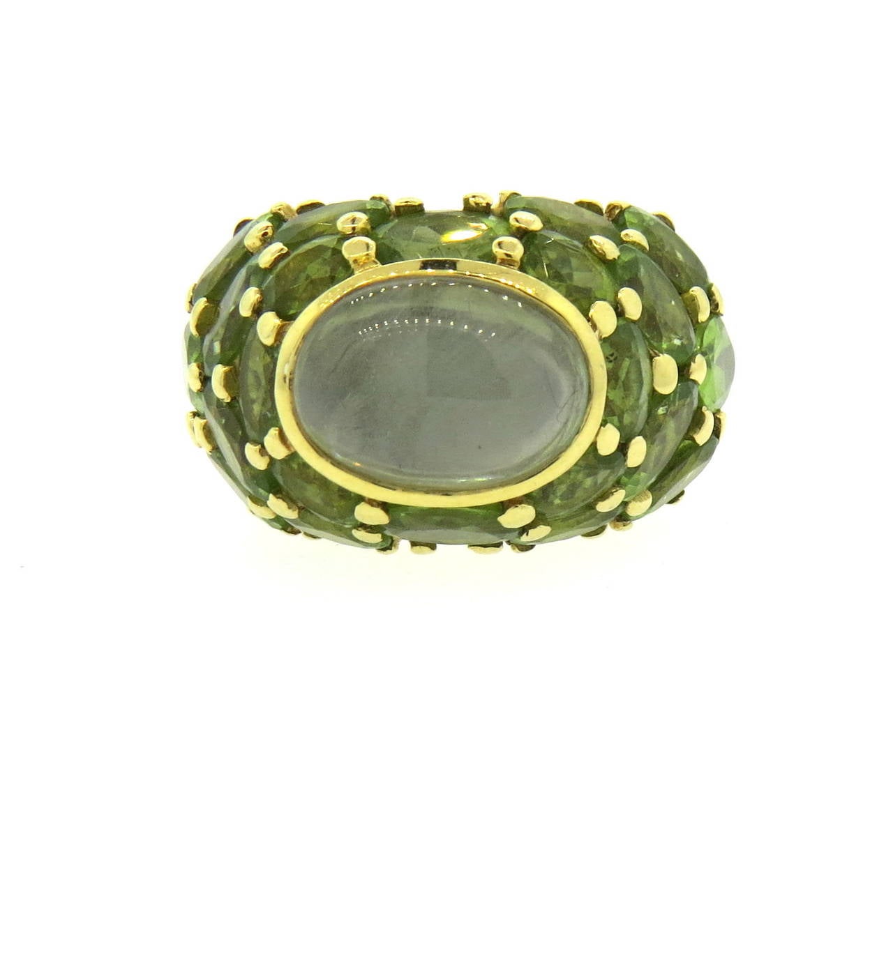 An 18k gold ring set with peridot and a quartz cabochon.  Crafted by Mimi So, the ring is a size 6.5 and 17.5mm wide.  It sits 12.2mm from finger and weighs 23.3 grams.