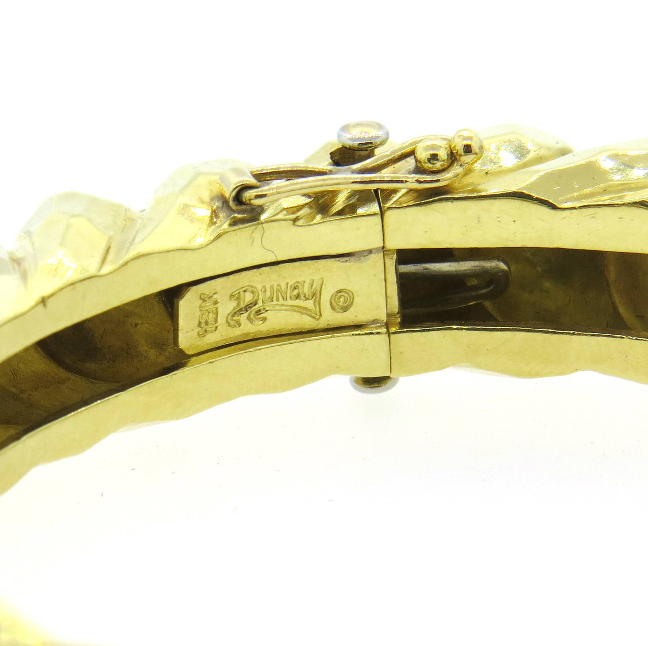 Stunning 18k gold hand-hammered bangle bracelet, signed DUNAY. 11mm wide . 
Will fit 6 1/2