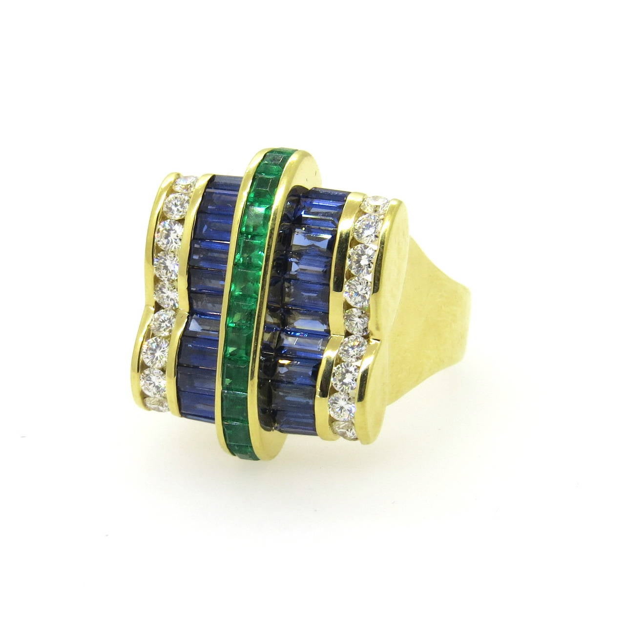 18k gold unusual ring by Krypell, featuring approx. 2.00ctw in baguette sapphires, 1.00ctw in square emerald and 0.80ctw in G/VS diamonds. Ring size 9, ring top is 24mm x 19mm. Marked Krypell 750. Weight - 23.7 grams