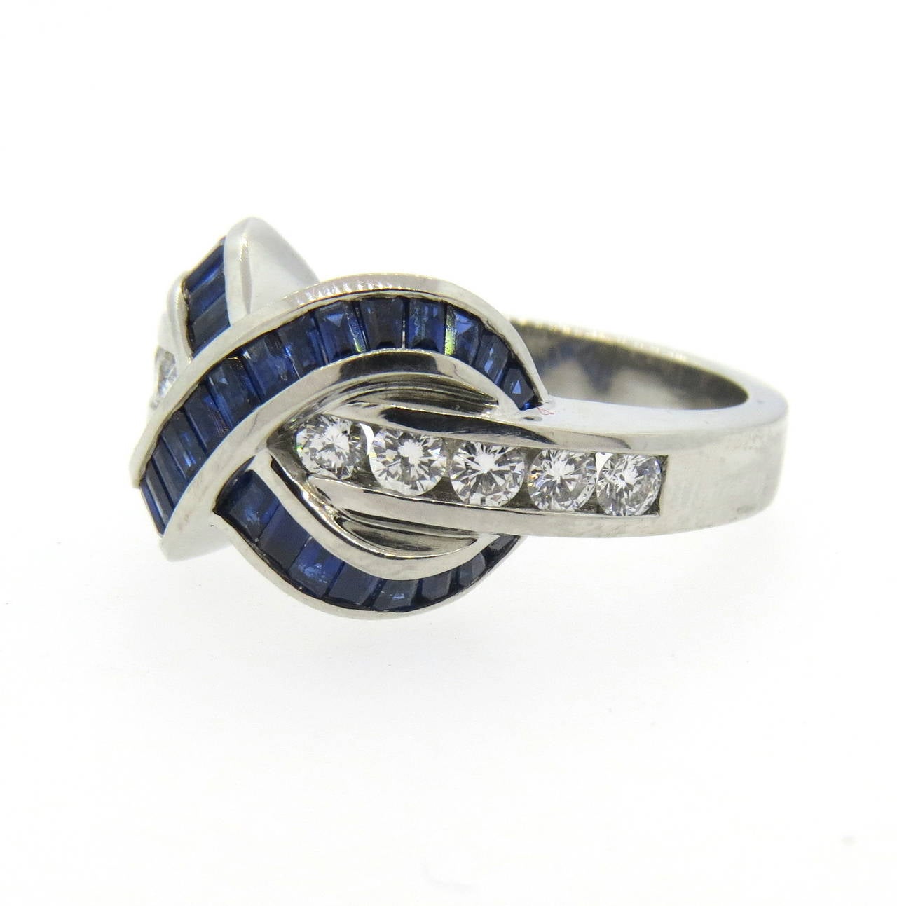 Platinum ring by Krypell, featuring designer's iconic look. Ring is a size 6 1/2, ring top is 13mm x 16mm.  Diamonds approx. 0.50ctw and sapphires are approx. 1.00ctw. Marked Krypell,950. Weight of the piece - 16 grams