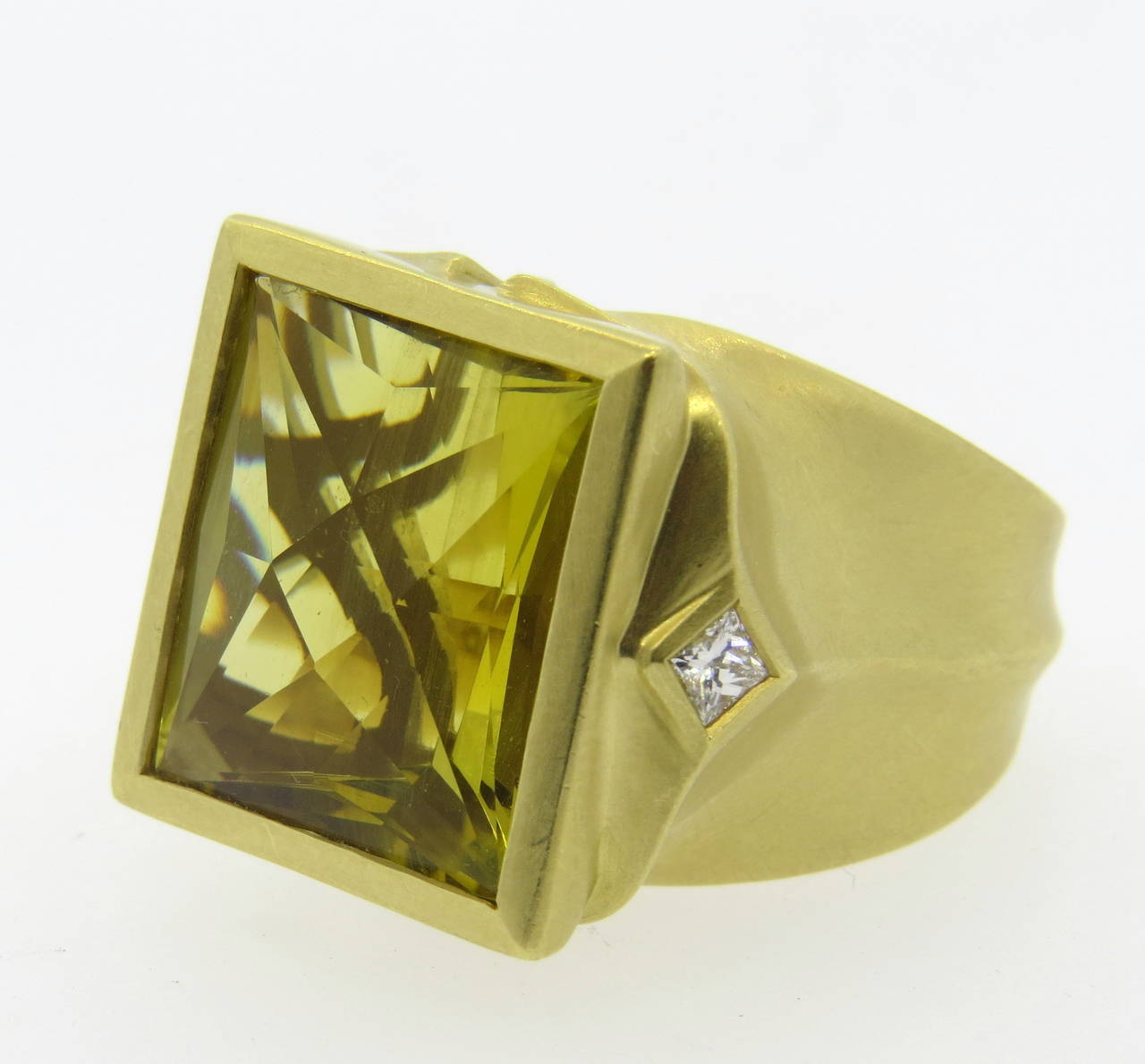 An 18k yellow gold ring set with a lemon citrine and approximately 0.30cts in G/VS diamonds.  Crafted by Elizabeth Rand, the ring is a size 9.  The top of the ring measures 21mm x 25mm and the ring sits 13.7mm from the finger.  The weight of the
