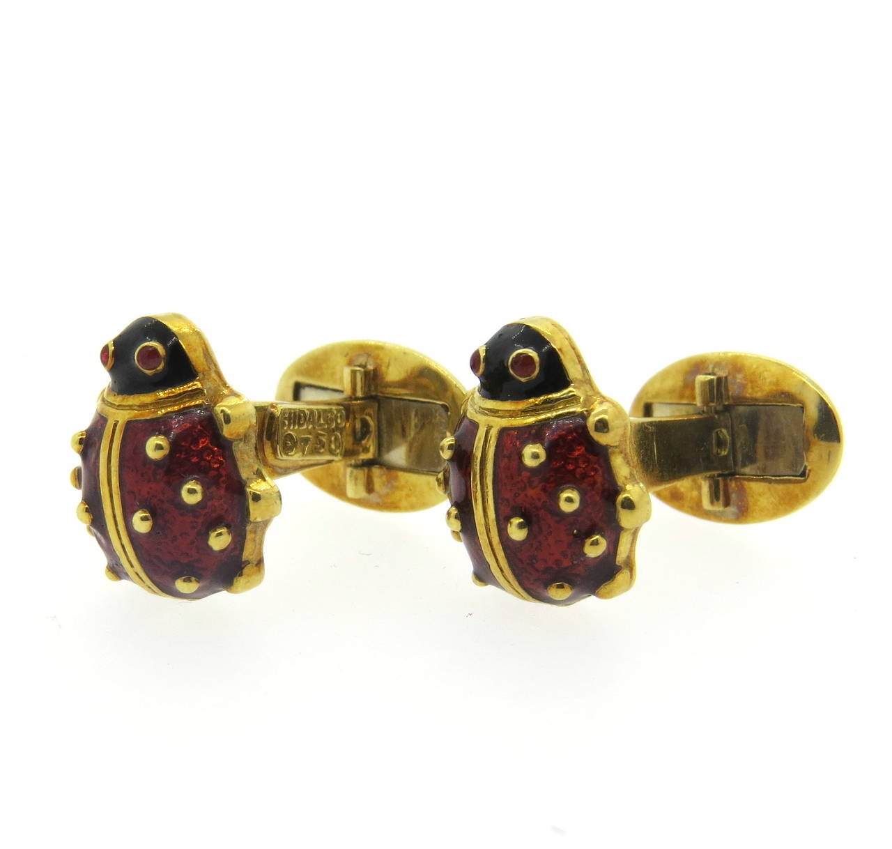 A pair of 18k yellow gold cufflinks coated with red enamel depicting ladybugs with garnet eyes.  Crafted by Hidalgo, the cufflinks measure 16mm x 13.8mm and weigh 15.0 grams.  Marked: Hidalgo, 750