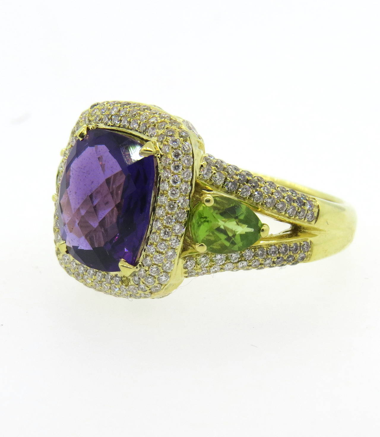 An 18k yellow gold ring set with diamonds (approx. 1.80cts), peridot (approx. 0.80ct) and amethyst (approx. 3.50ct).  Crafted by Charles Krypell, the ring is a size 10 and weighs 13.4 grams.  Marked: Krypell, 750.