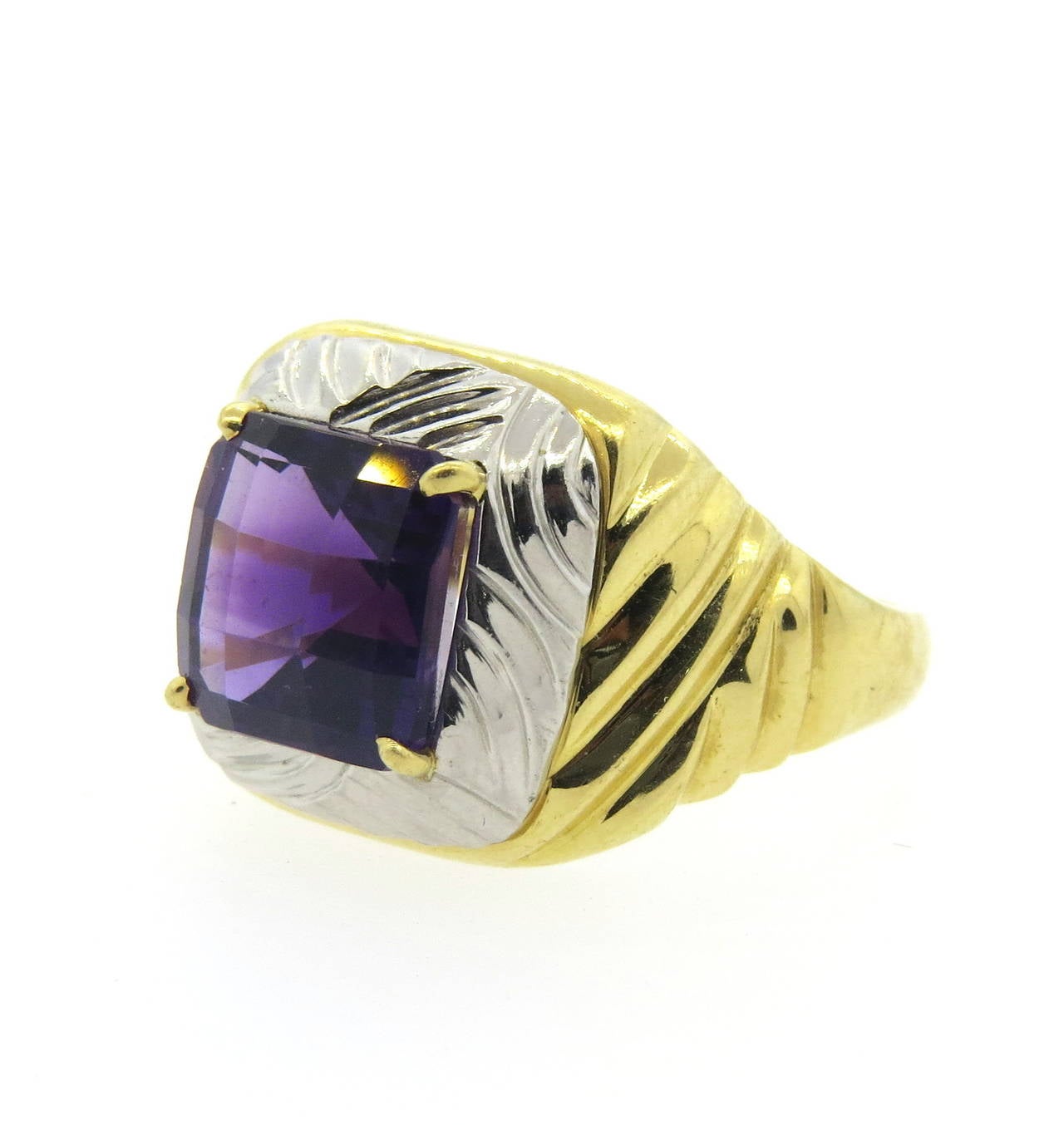 An 18k yellow gold and platinum ring, set with an amethyst weighing approximately 4.50ct.  Crafted by Michael Bondanza, the ring is a size 8.25 and 16.4mm wide