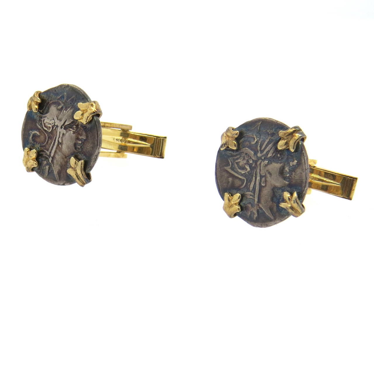 A pair of 14k yellow gold cufflinks set with ancient coins ( metal or bronze).  The coins measure 18mm in diameter 13.3 grams.  Marked: 14k.