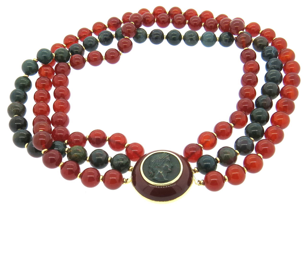Trianon multi strand necklace, featuring 10mm carnelian and bloodstone beads, enhanced with 30mm 14k gold clasp, featuring bloodstone intaglio and carnelian (clasp can be detached and worn a s a brooch). Necklace is 16