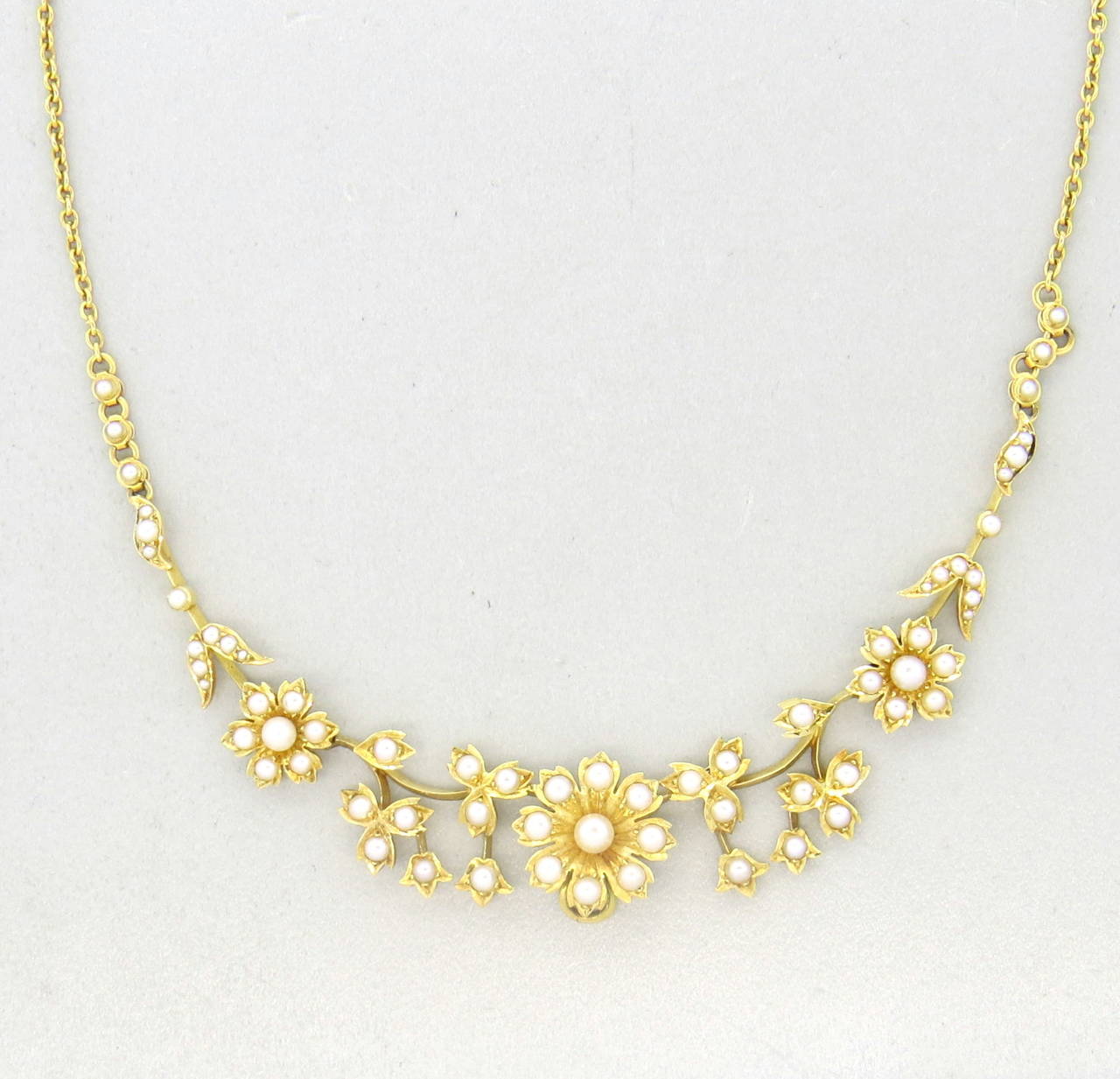 A 15k yellow gold necklace set with pearls ( 2mm - 3.6mm)  retailed originally by Hall & Co. of Manchester in original fitted box.  The necklace measures 15