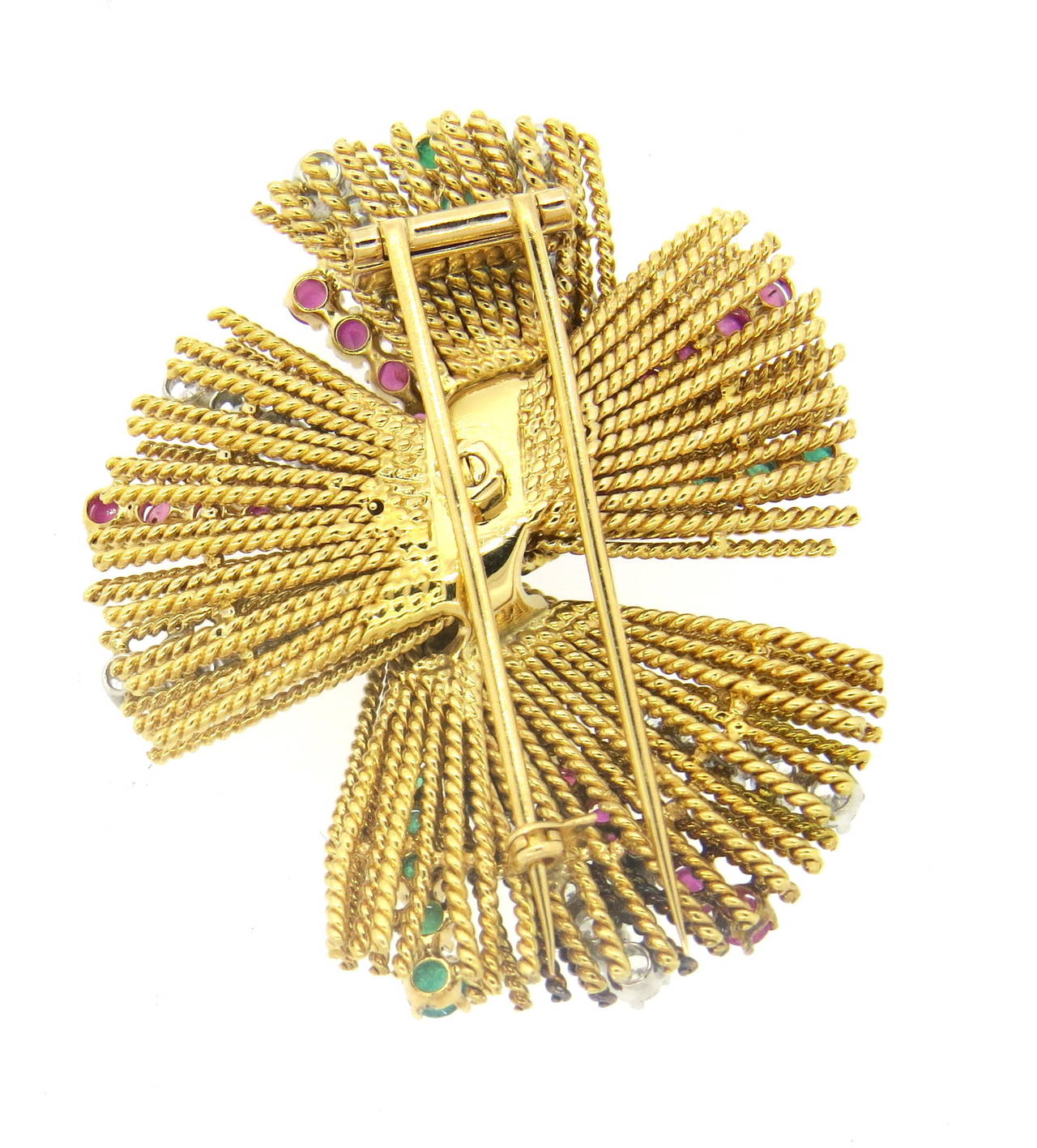 An 18k yellow gold brooch set with approximately 2.50ctw in G-H/VS-SI1 diamonds, rubies and emeralds.  The brooch measures 54mm x 45mm and weighs 43.1 grams.