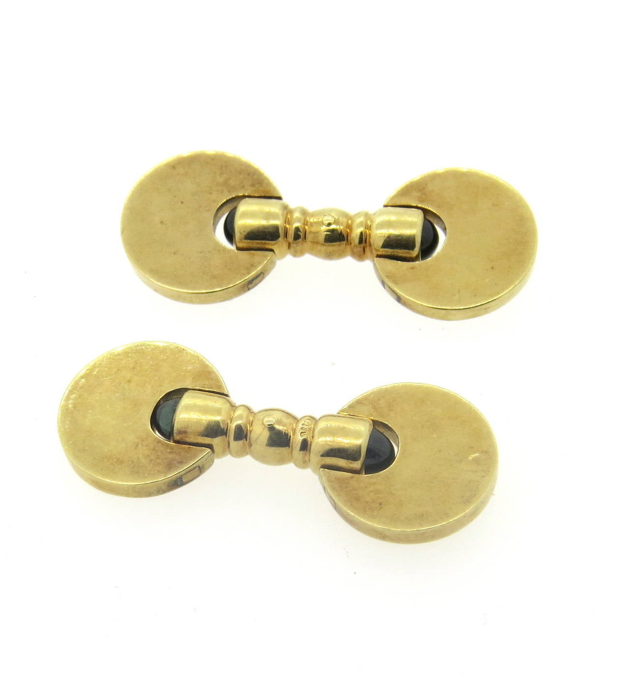 A pair of 14k yellow gold cufflinks set with sapphire cabochons.  Cufflinks measure 14mm in diameter.  The weight of the cufflinks is 20 grams.  Marked: 14k.