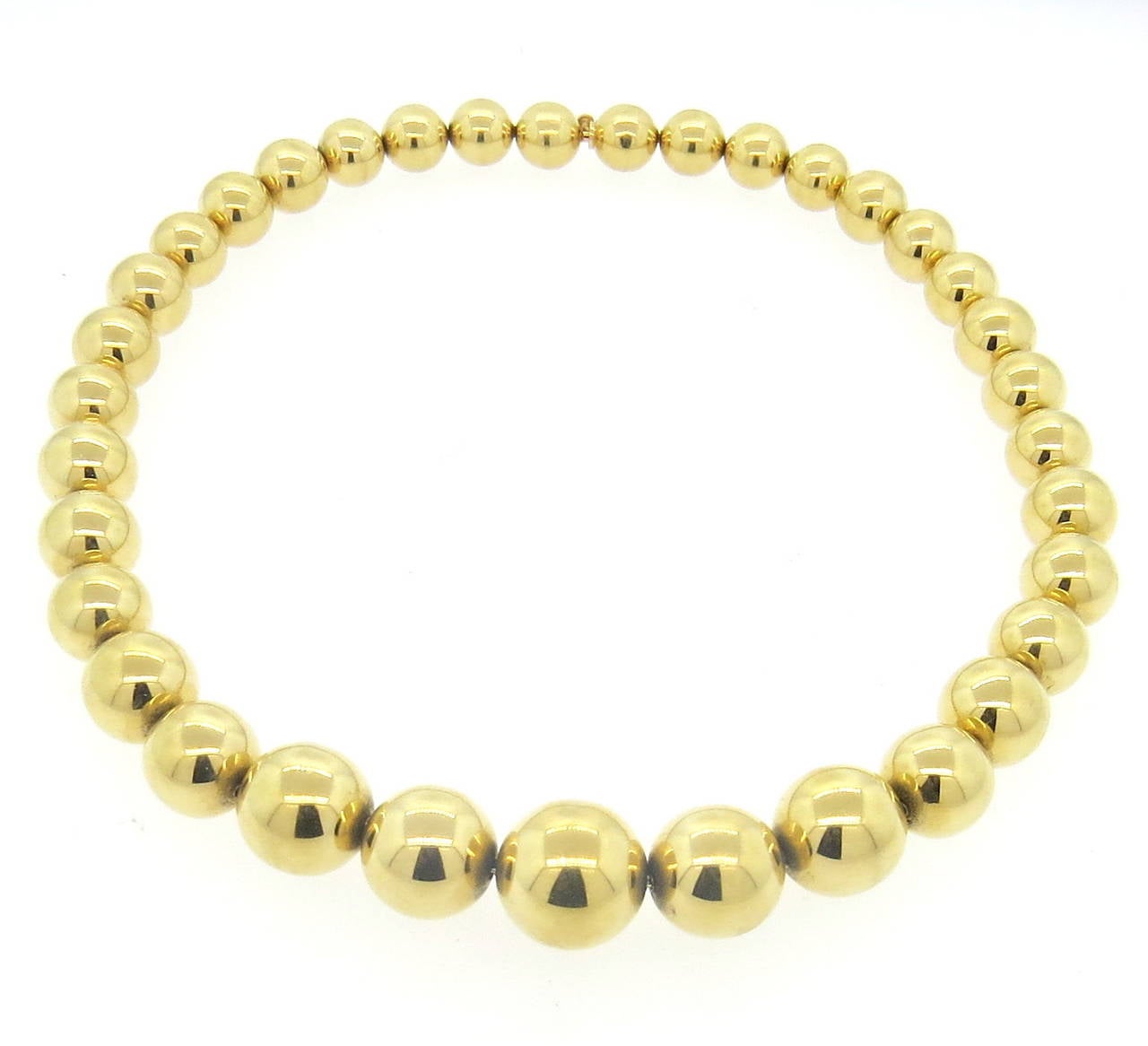 A 14k yellow gold antique necklace comprised of gold ball beads ranging in size from 9.5mm to 16.8mm in diameter.  The necklace measures 16