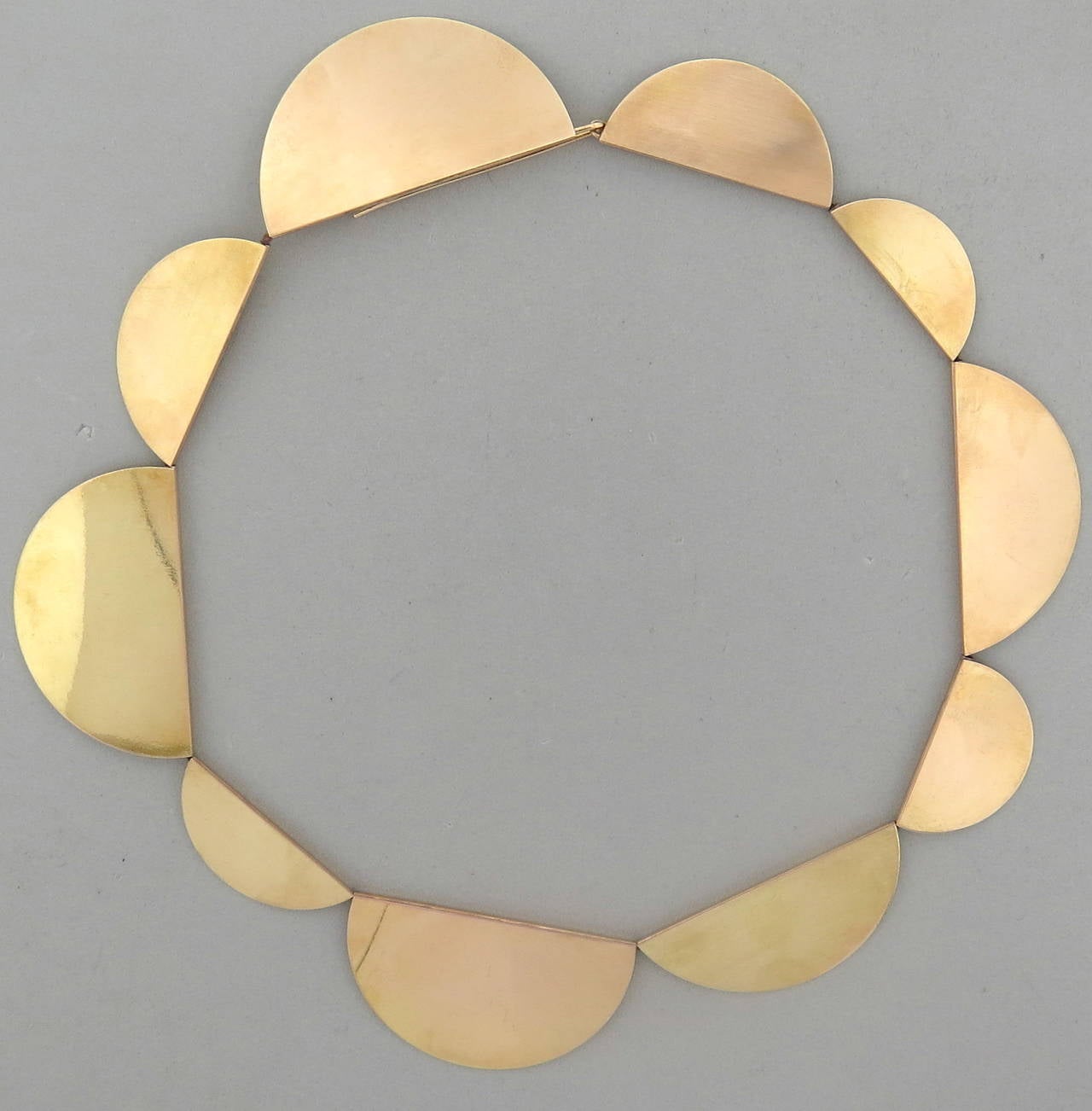 A 14k yellow gold necklace in the Modernist style.  Crafted by Betty Cooke, the necklace measures 17.25