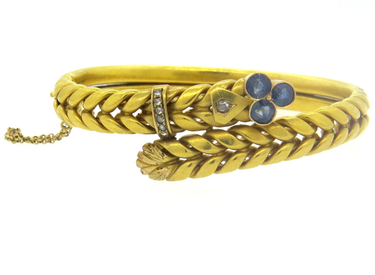 Antique 18k gold bangle, decorated with rose cut diamonds and blue sapphires. Bracelet will fit up to 7