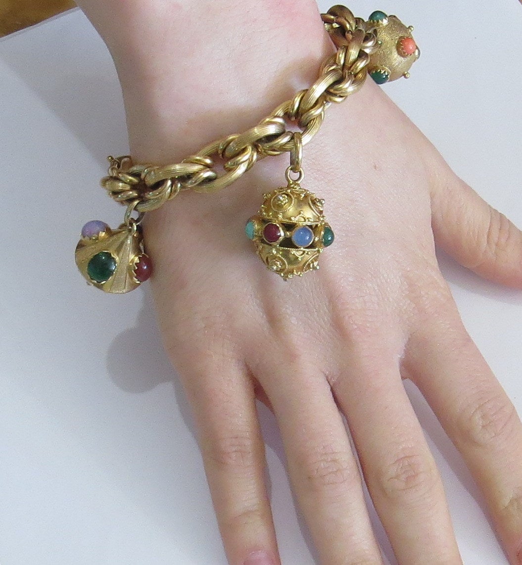 18k gold bracelet, featuring 3D charm pendants with multicolor gemstones. Bracelet is 8 1/2