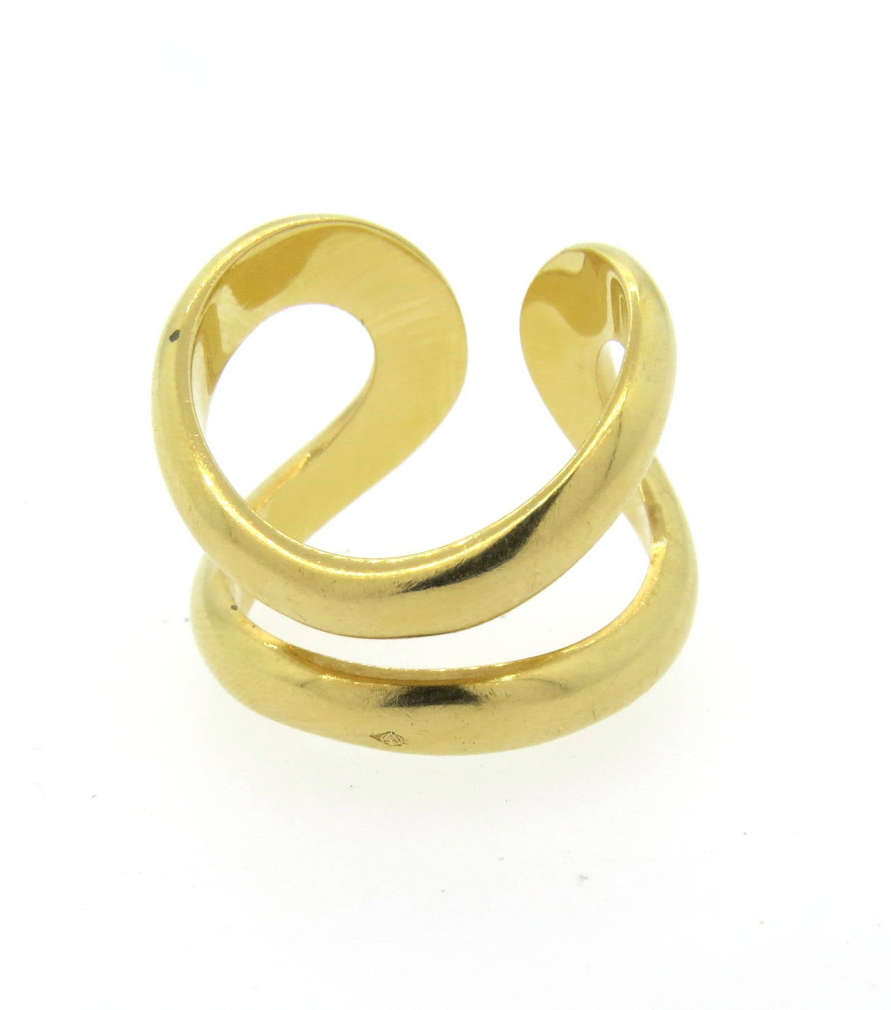 An 18k yellow gold ring.  Crafted by Hermes, the ring is 20mm at the widest point and a size 60 (US size 9.5).  The weight of the ring is 18.1 grams.