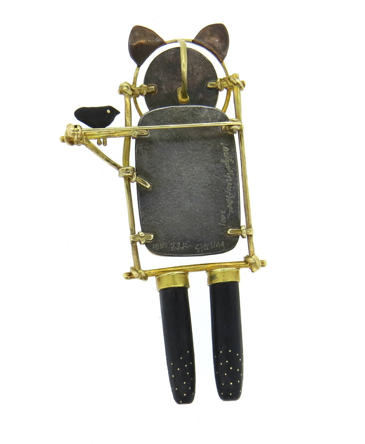 Unusual brooch pendant by Carolyn Morris Bach, set in sterling silver,18k and 22k gold, decorated with cow bone,wood and gemstone. Measures 87mm x 41mm. Marked Carolyn Morris Bach 2001, 18k 22k sterling. Weight of the piece - 28.9 grams