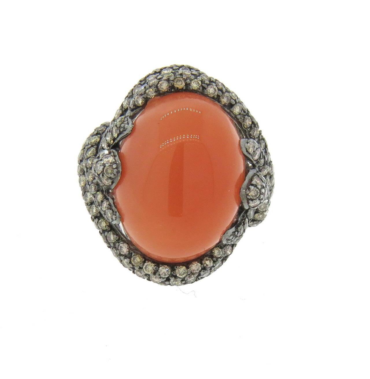 Beautiful 18k gold ring, set with oval peach moonstone cabochon, surrounded with approximately 3.80ctw in fancy diamonds. Ring is a size 7, top of the ring is 26mm x 23mm. Weight of the ring - 14.5 grams