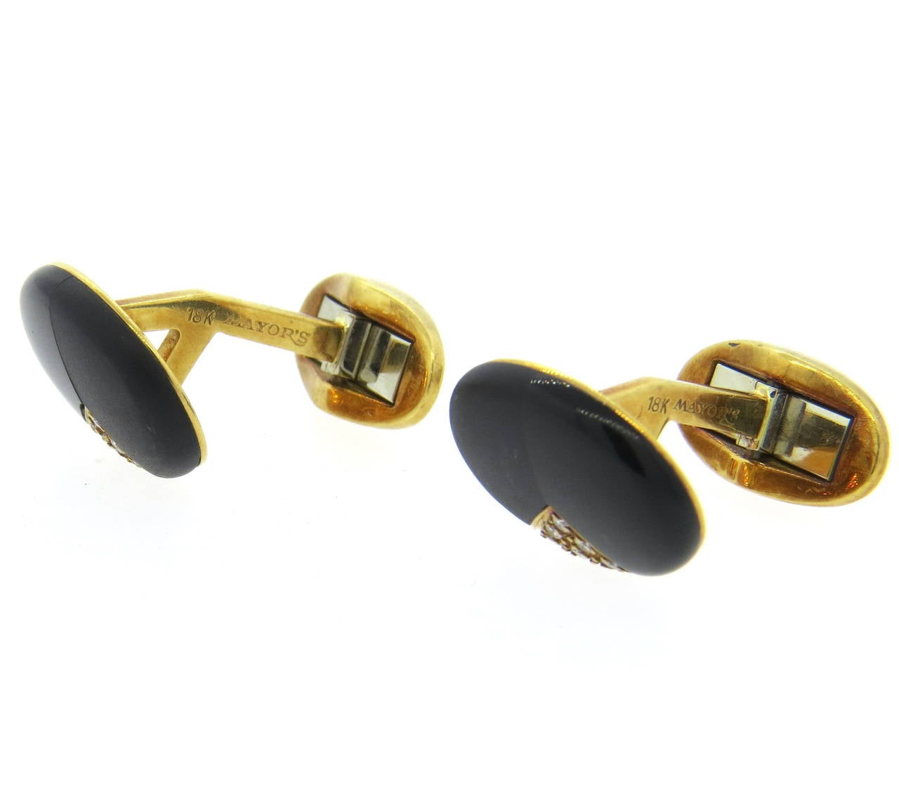 18k gold oval cufflinks, featuring onyx and black hardstone with approx. 0.15ctw in G/Vs diamonds. Cufflink top is 17mm x 14mm. Weight - 15.1 grams