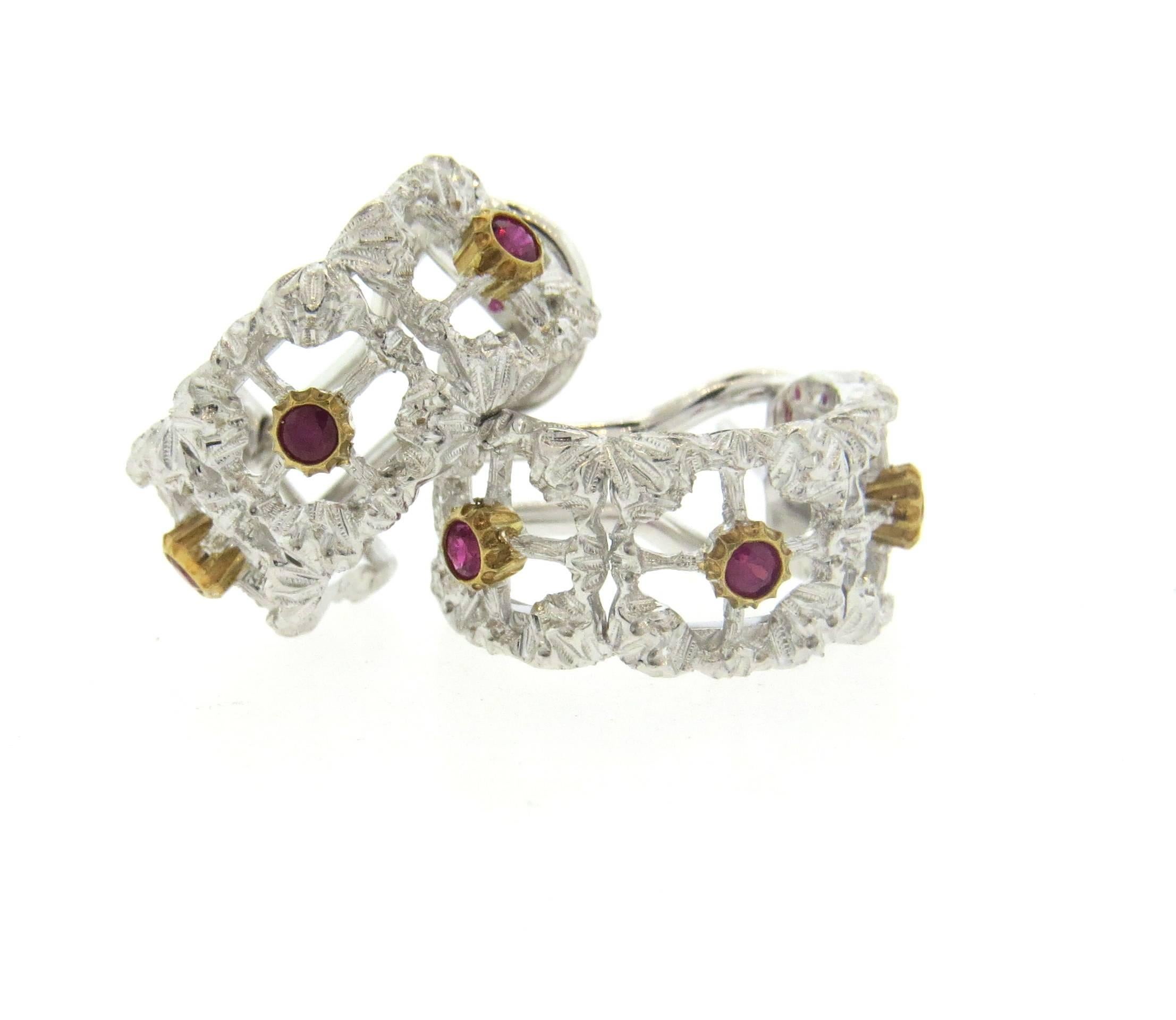 A pair of 18k white and yellow gold hoop earrings, crafted by Buccellati, decorated with rubies. Earrings are 17mm in diameter x 9mm wide  . Marked: Buccellati Italy 18k F5462. Weight - 10 grams 