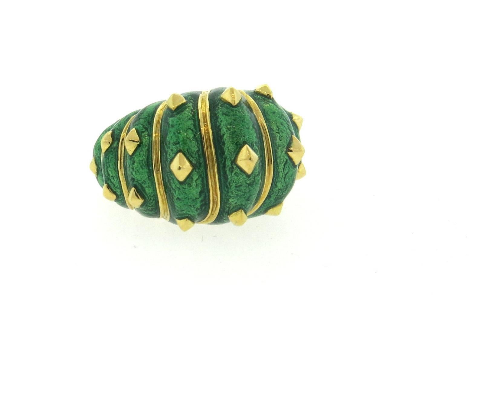 An 18k yellow gold ring adorned with green enamel.  Crafted by David Webb, the ring is a size 6 1/2, ring top is 17mm wide and sits approx. 15mm from the finger. Marked: Webb 18k.  The weight of the piece is 25.1 grams.