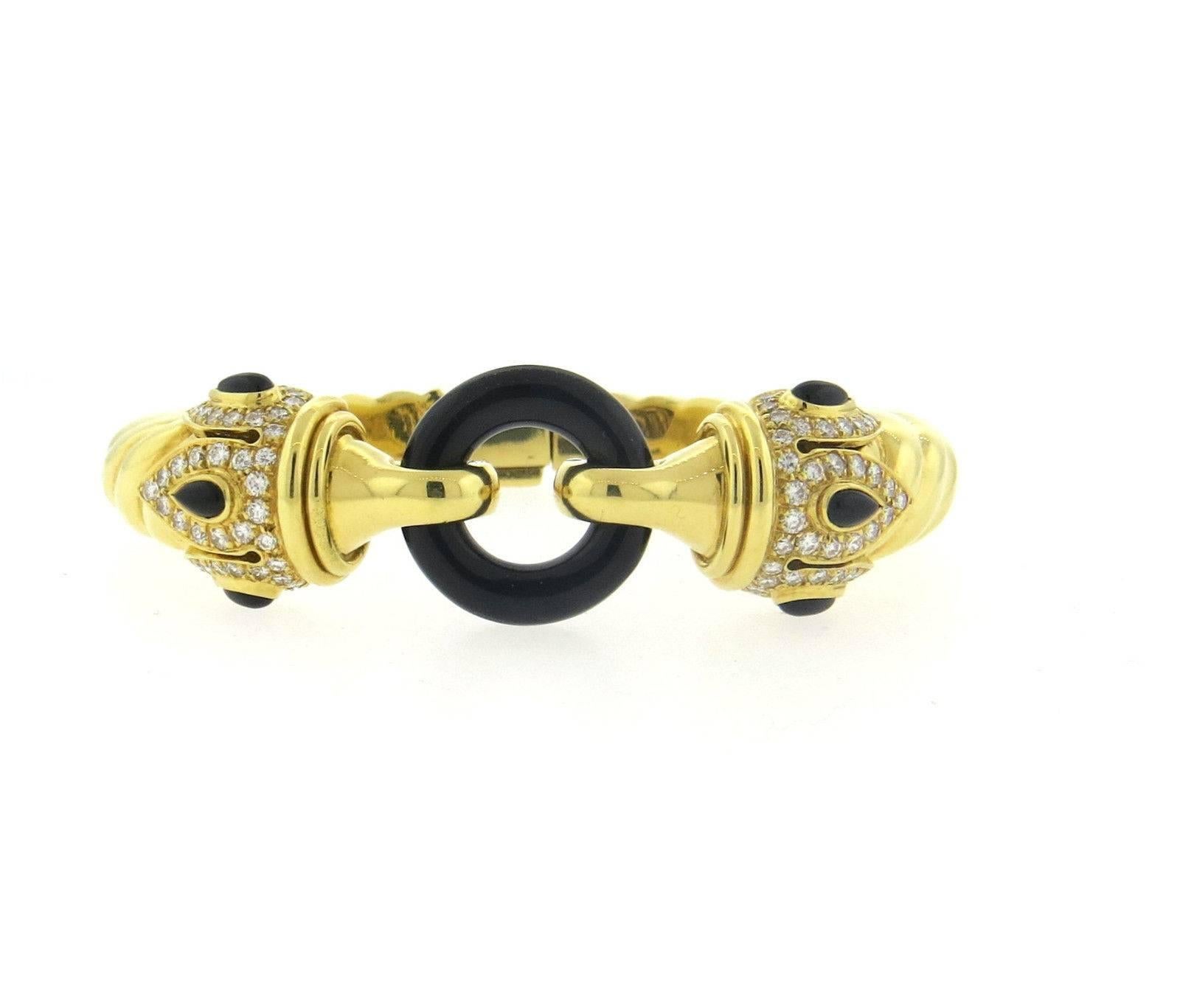 An 18k yellow gold bracelet set with approximately 1 carat of GH/VS diamonds and onyx.  Crafted in Italy, the bracelet will fit up to 7