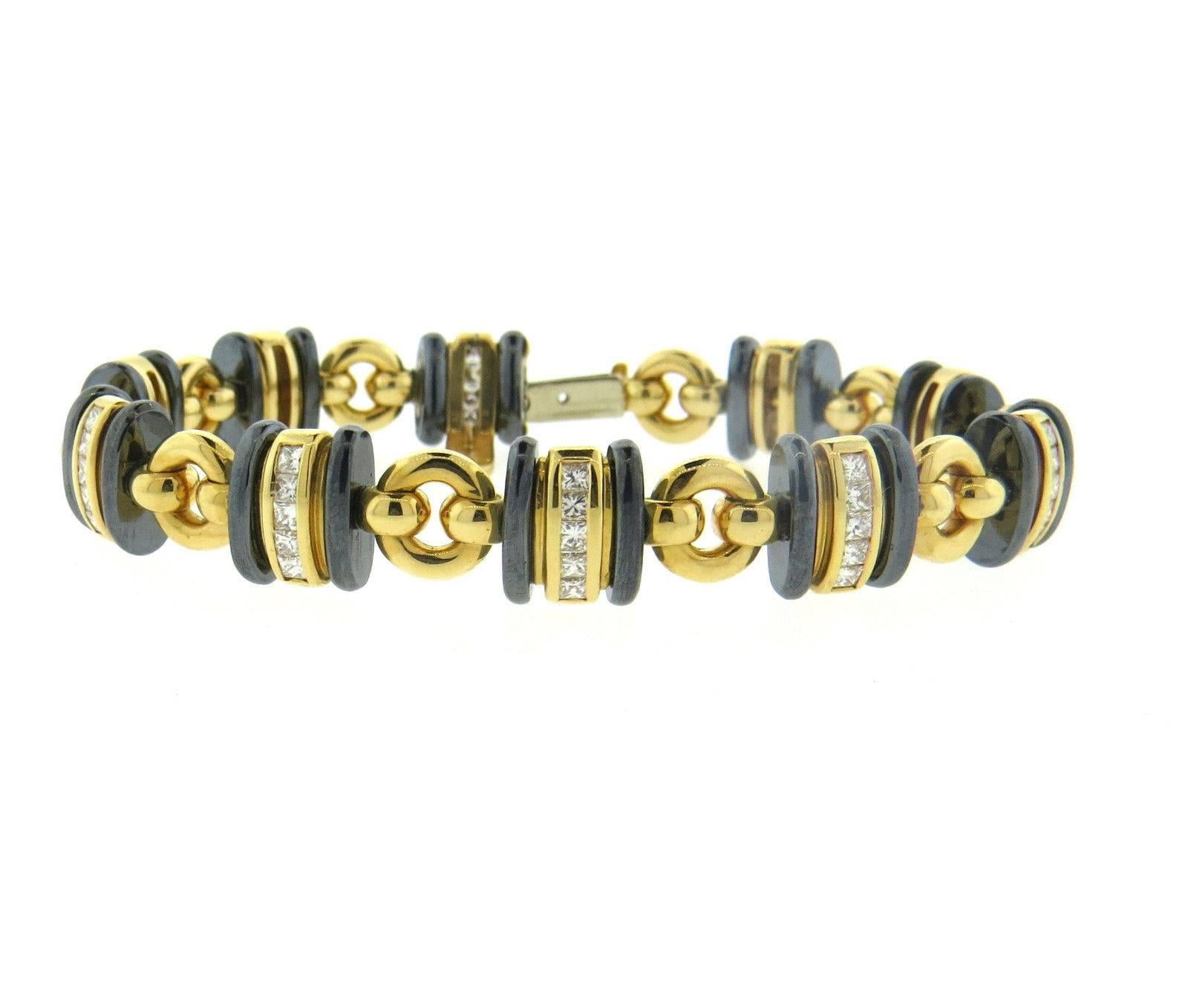 An 18k yellow gold bracelet set with approximately 2.00ctw of G/VS diamonds and hematite links. The bracelet is  7 1/4